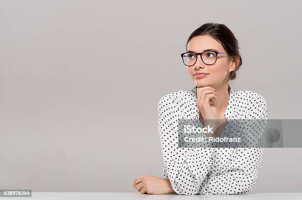 Young Woman Thinking Stock Photo - Download Image Now - Women, Contemplation, Eyeglasses