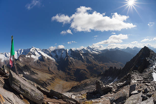 istock Italian flag over a mountain peak in Ahrntal 618976288