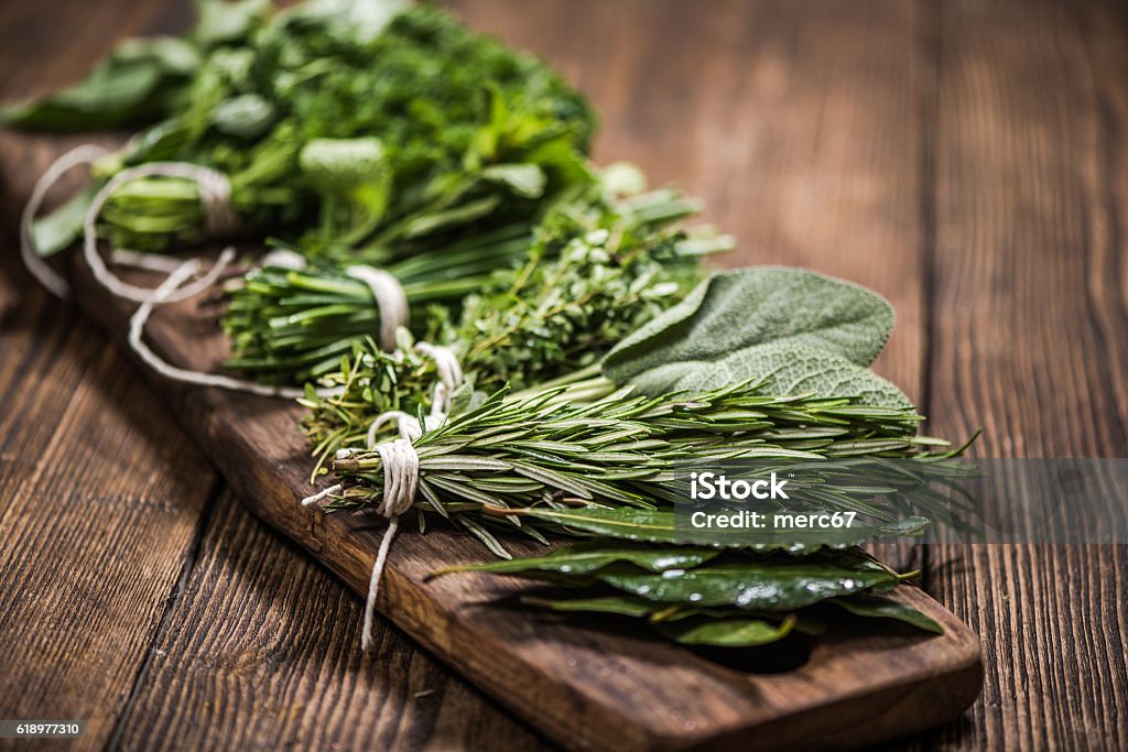 natural aromatic herbs natural aromatic herbs on wooden board Herb Stock Photo