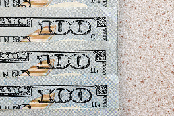 istock Hundred dollar bills, on vintage light tone wooden 618978402