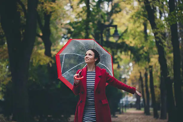 Photo of Beautiful young woman enjoying a rainy day