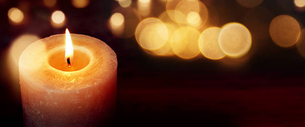 Candles with golden lights Candles with golden lights against a dark background with bokeh botanical spa treatment stock pictures, royalty-free photos & images