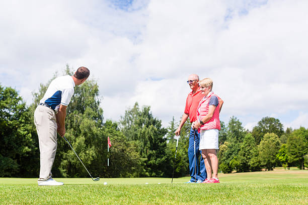 istock Golf pro practicing the sport with senior woman and man 618980360