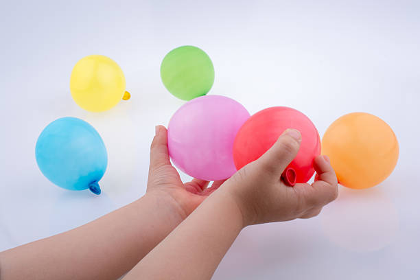 istock Hand holding a Colorful small balloon in hand 618981200
