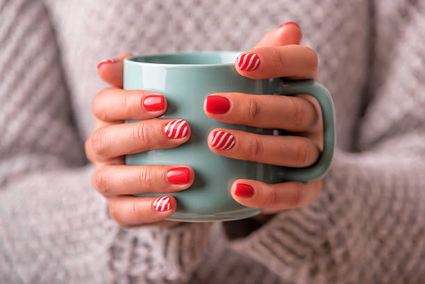 istock Women's hands holding a cup of drink. 618981284