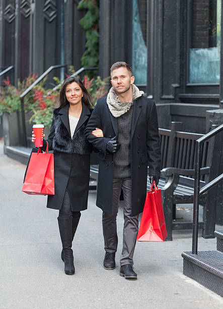 istock Attractive couple walking with shopping bags 618981528
