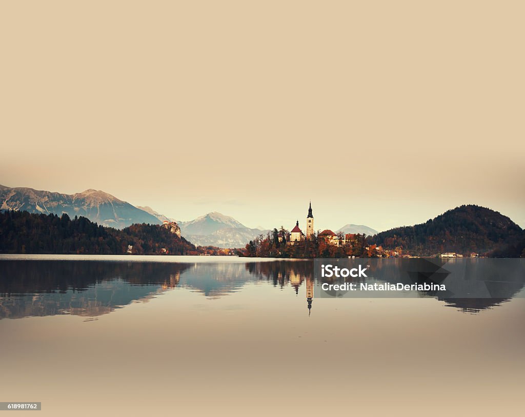 Amazing Bled Lake on sunset, Slovenia, Europe Amazing View On Bled Lake. Autumn in Slovenia, Europe. View on Island with Catholic Church in Bled Lake with Castle and Mountains in Background. Arranging Stock Photo
