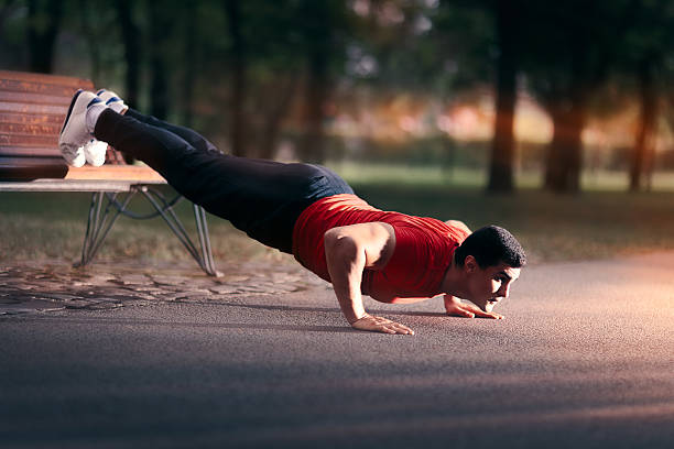 istock Fitness Man doing a Bench Press Up Outside 618982614