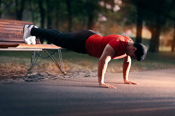 istock Fitness Man doing a Bench Press Up Outside 618982620