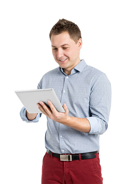 Happy Young Man Using Digital Tablet Happy Young Man Using Digital Tablet Isolated On White Background business person one man only blue standing stock pictures, royalty-free photos & images