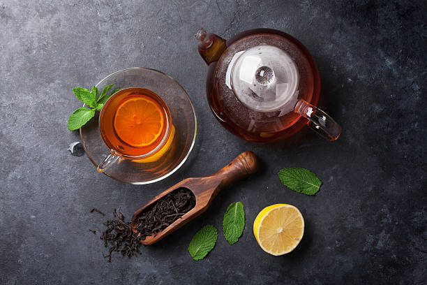 istock Tea cup, teapot and dry tea in spoon 618983264
