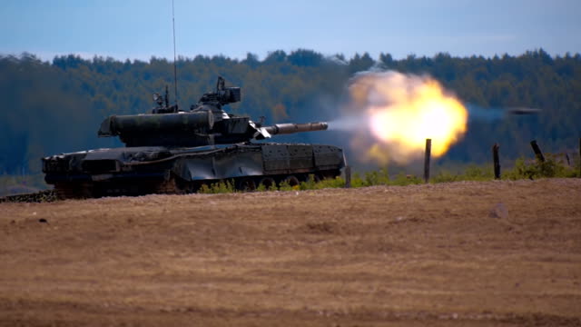 Tank T-90 is on the range and shoot at targets during military exercises