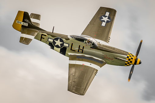 East Kirkby, UK - August 6, 2016: a North American P-51D Mustang fighter aircraft of WWII in flight over Lincolnshire, England. 