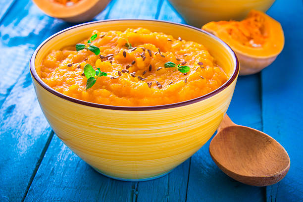 istock Pumpkin cream soup with mint in a bowl 619044290