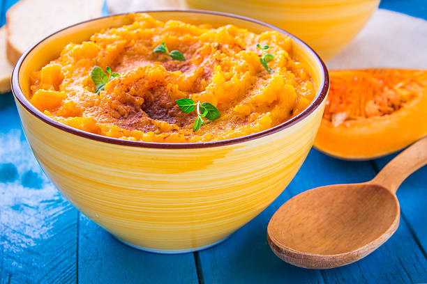 istock Pumpkin cream soup with mint and bread in a bowl 619044468