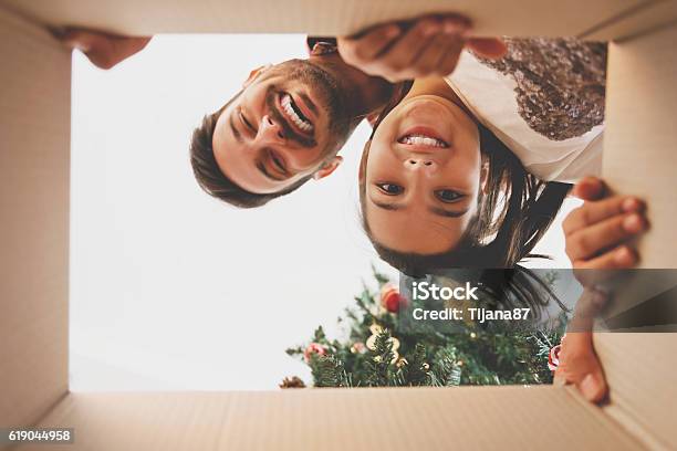 Father And Daughter Opening A Christmas Present Stock Photo - Download Image Now - Gift, Christmas, Family