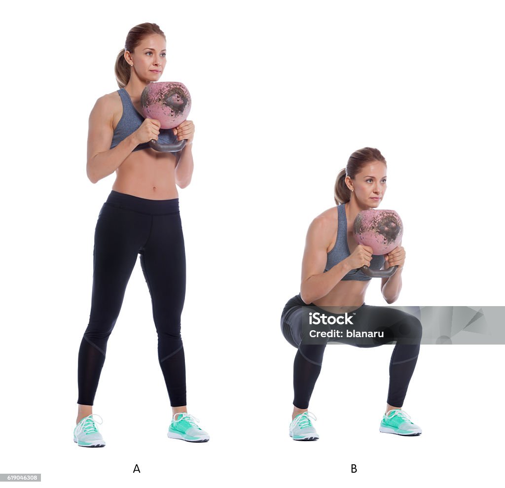 Kettlebell front squat Athletic woman performing a functional exercise with kettlebell. Kettlebell Stock Photo