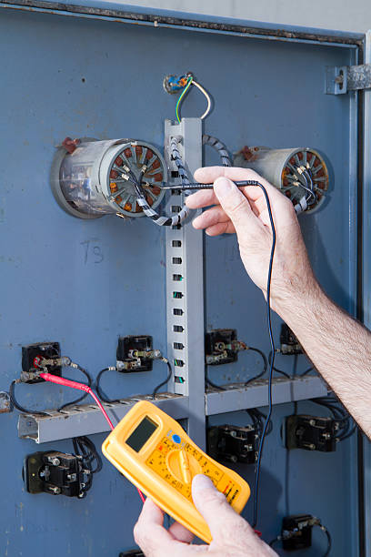 istock electrician at work with an electric panel 619046634