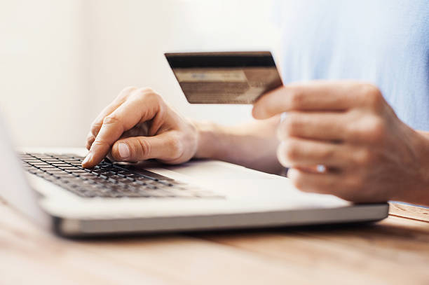 istock Man is shopping online with laptop 619048124