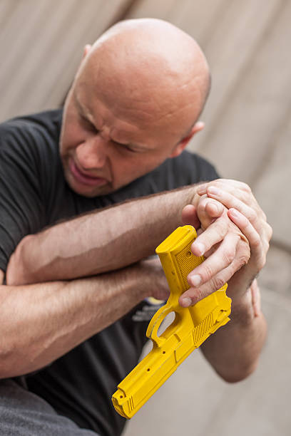 istock Gun Disarm. Self defense techniques against a gun point. 619051274