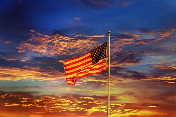 istock American flag in front of bright sky 619051774