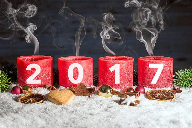 istock Four blown out advent candles with 2017 in snow 619052704
