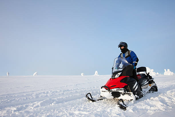 istock Man driving snowmobile in Finland 619052822