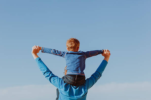 istock happy father and son playing on sky 619052868