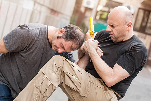 istock Gun Disarm. Self defense techniques against a gun point. 619053222