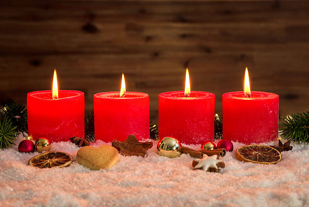 istock Four advent candles lit in snow 619053538