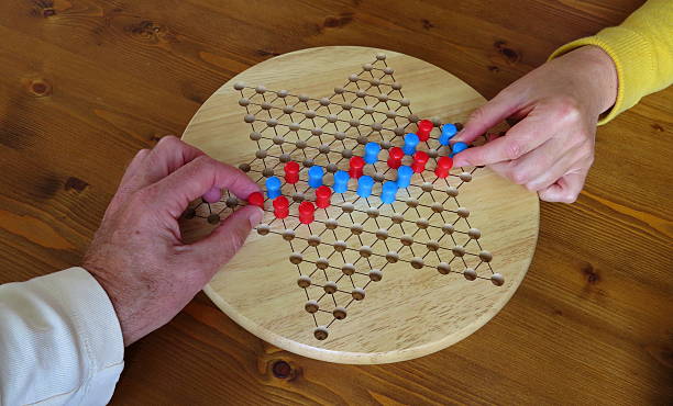 Connecting through playing a game Connecting with other people through playing a game. Chinese checkers. chinese checkers stock pictures, royalty-free photos & images