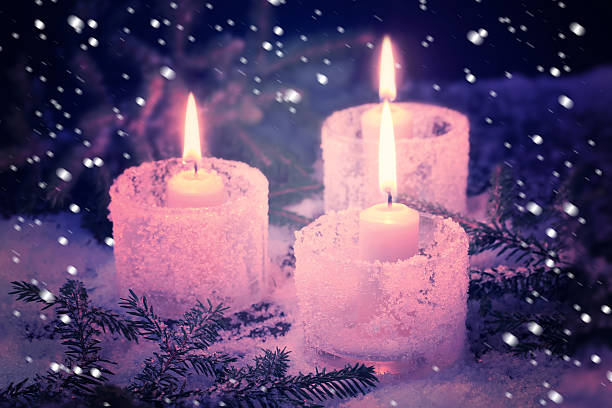 istock burning candles on a winter background 619056166