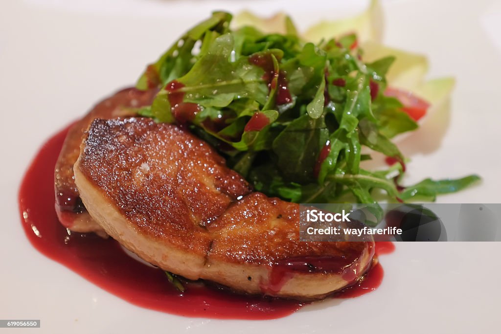 Grilled foie gras steak with green salad Foie Gras Stock Photo