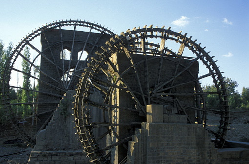 a traditional norias wooden water wheelsl in the city of Hama in Syria in the middle east