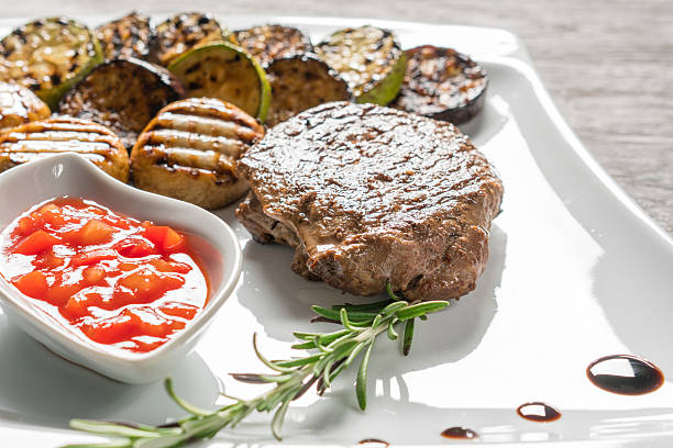 istock Appetizing stake on white plate. Grilled meat 619057056