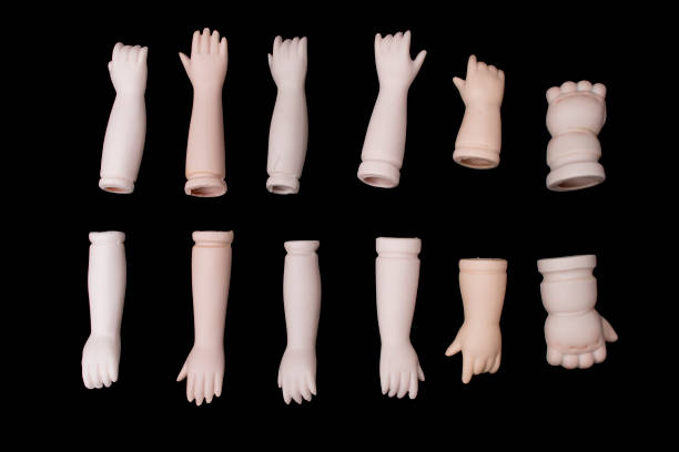 istock Broken Doll Body Parts Hands and Arms on Black Background 619057658
