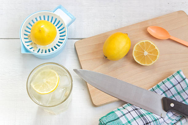 istock Lemonade with fresh lemon on white wooden background 619059422