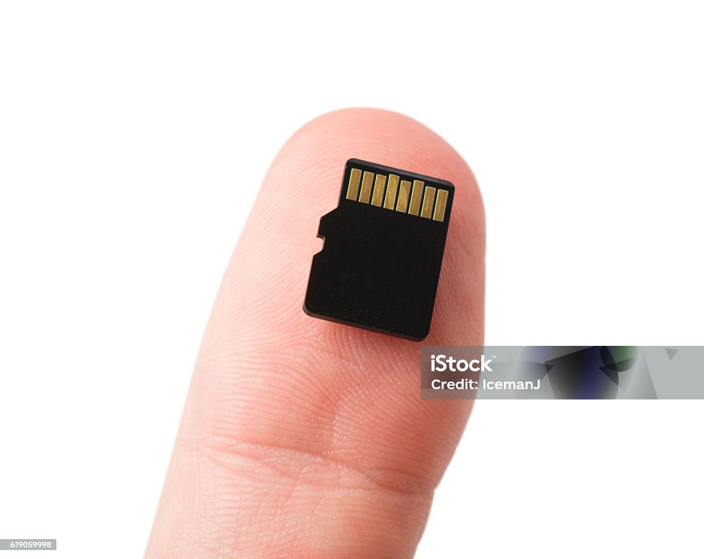 Micro SD Card on Thumb A micro SD Card on a caucasian male's thumb, isolated on white. Adult Stock Photo