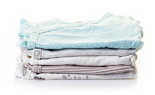 istock Pile of baby clothes isolated on white 619061606