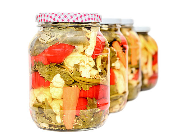 Jar with pickles containing cauliflower, cucumber, red pepper