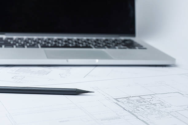 istock black pencil on architectural drawing paper and rolls for construction 619063938