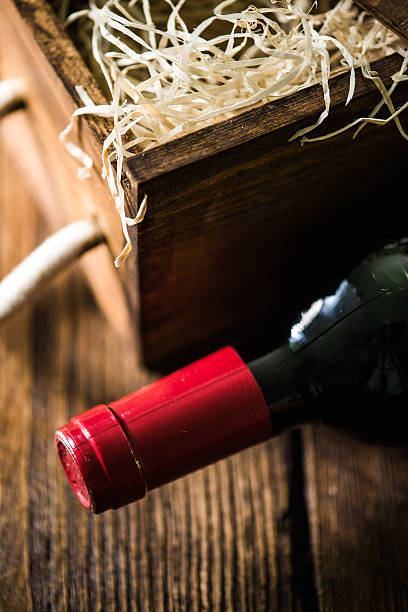 istock Red wine bottle and wooden crate 619064104