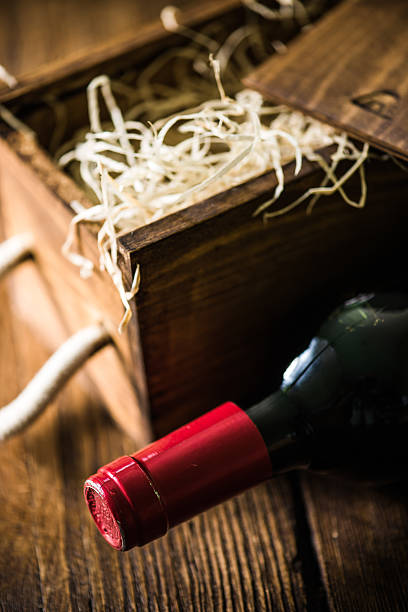 istock Red wine bottle and wooden crate 619064214