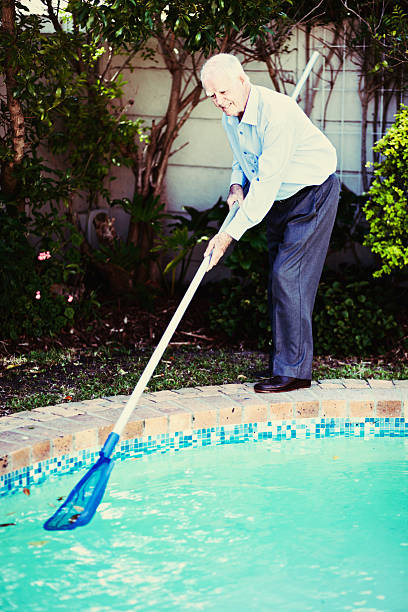 istock Active seniors: a fit, happy 90-year-old man cleans swimming pool 619064840