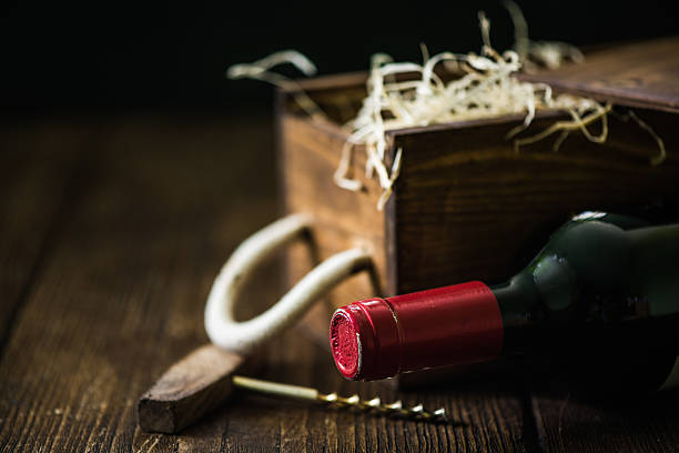 istock Red wine bottle and wooden crate 619065148