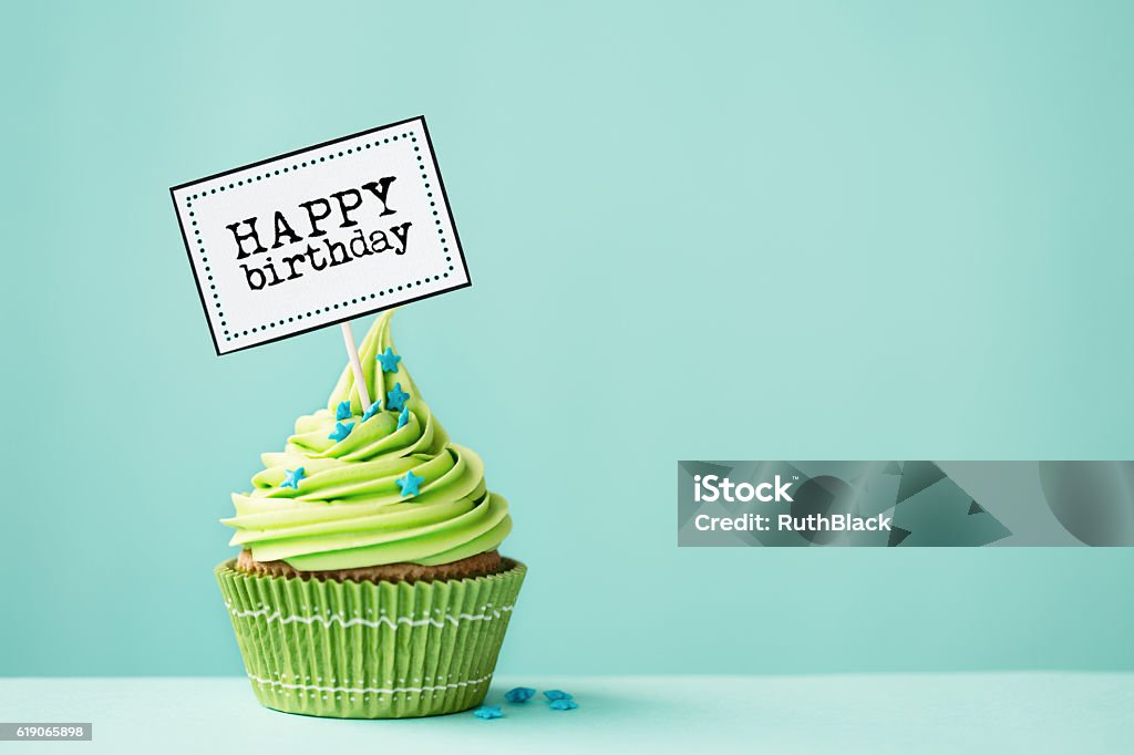 Birthday cupcake Cupcake with Bake Sale sign Green Color Stock Photo