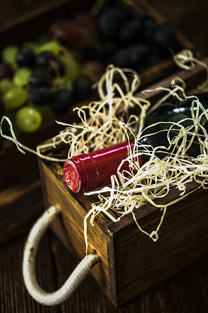 istock Red wine bottle in case, still life 619066684