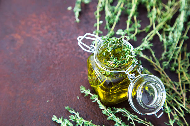 istock Thyme oil. Thyme essential oil jar glass bottle 619067396