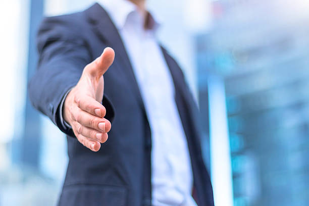 istock Businessman with an open hand ready for handshake 619067404
