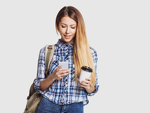istock Happy young student girl using smart phone 619067490